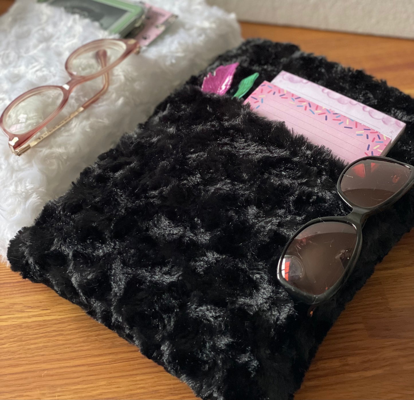 Extra soft and fluffy is the black book sleeve pouch with an large pocket. Extremely soft texture and fabric.