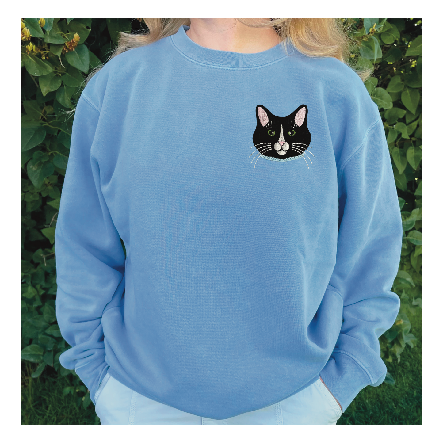 Tuxedo Black and White Cat Embroidered Crewneck Sweatshirt. Design is 4x4 inches left chest. Available in sizes S-3XL on Baby Blue Sweatshirt.