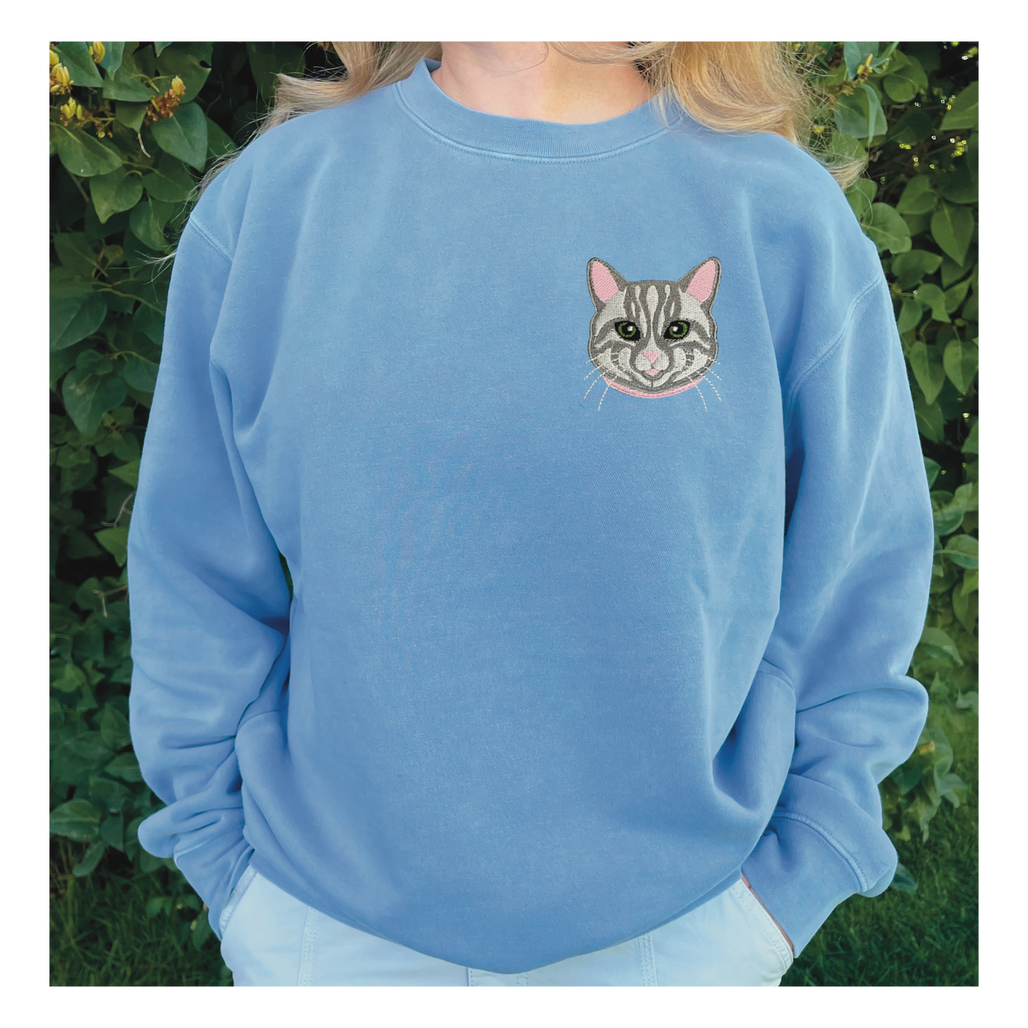 Gray Tabby Cat Embroidered Crewneck Sweatshirt. Design is 4x4 inches left chest. Available in sizes S-3XL on Baby Blue Sweatshirt.