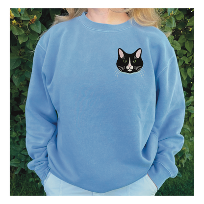 Tuxedo Black and White Cat Embroidered Crewneck Sweatshirt. Design is 4x4 inches left chest. Available in sizes S-3XL on Baby Blue Sweatshirt. 
