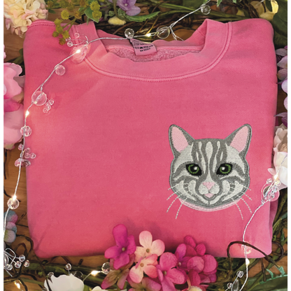 Gray Tabby Cat Embroidered Crewneck Sweatshirt. Design is 4x4 inches left chest. Available in sizes S-3XL on Pigment Pink Sweatshirt. 