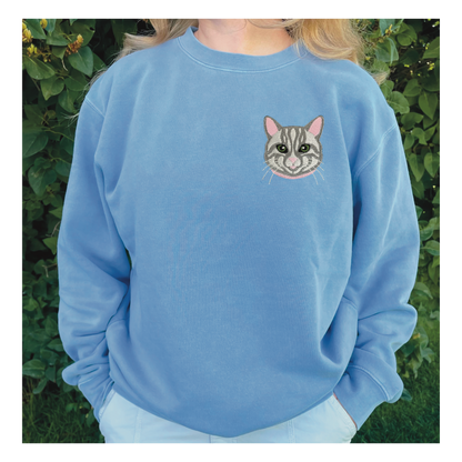 Gray Tabby Cat Embroidered Crewneck Sweatshirt. Design is 4x4 inches left chest. Available in sizes S-3XL on Baby Blue Sweatshirt. 