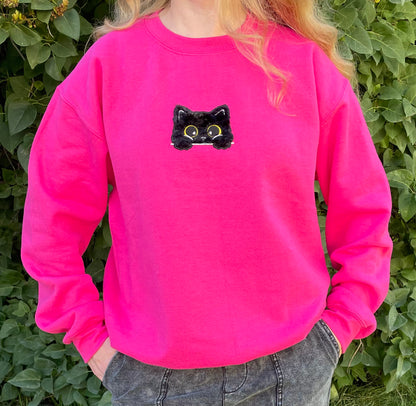 This sweatshirt crewneck is Dark Neon Pink embroidered with a super soft black fluffy (faux) fur kitty on the center front chest. Kitty looks like she is poking out of a pocket (Not a real pocket) with her big harvest gold eyes staring back at you. Unisex fit, mid-weight fabric, Material: 50% cotton / 50% polyester Blend.