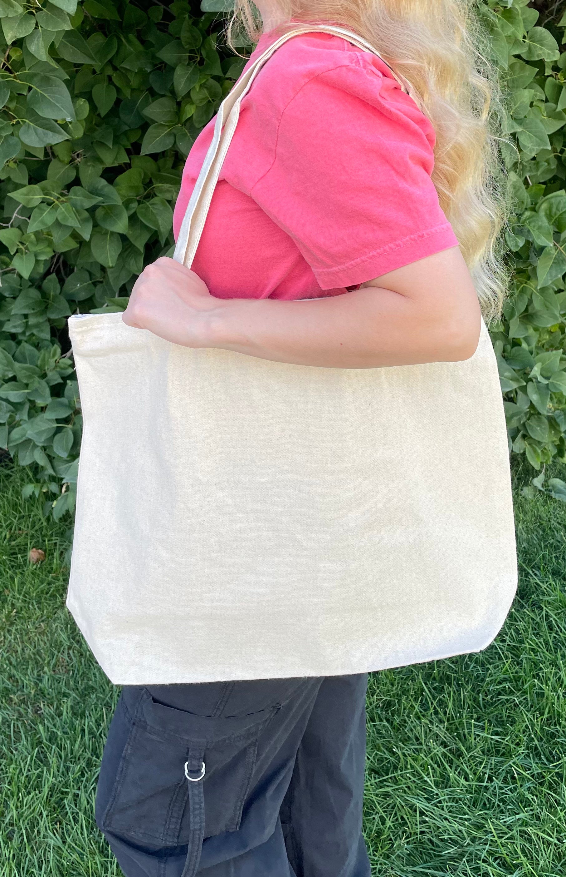 Large zippered canvas tote bag with small zippered pocket inside. 