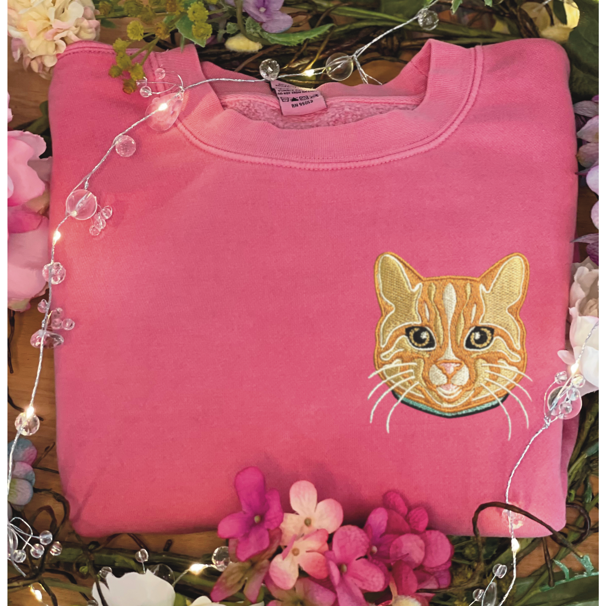 Orange Cat personalized Sweatshirt, embroidered orange cat left chest 4x4 inches on pigment pink sweatshirt. Available in sizes S-3XL.