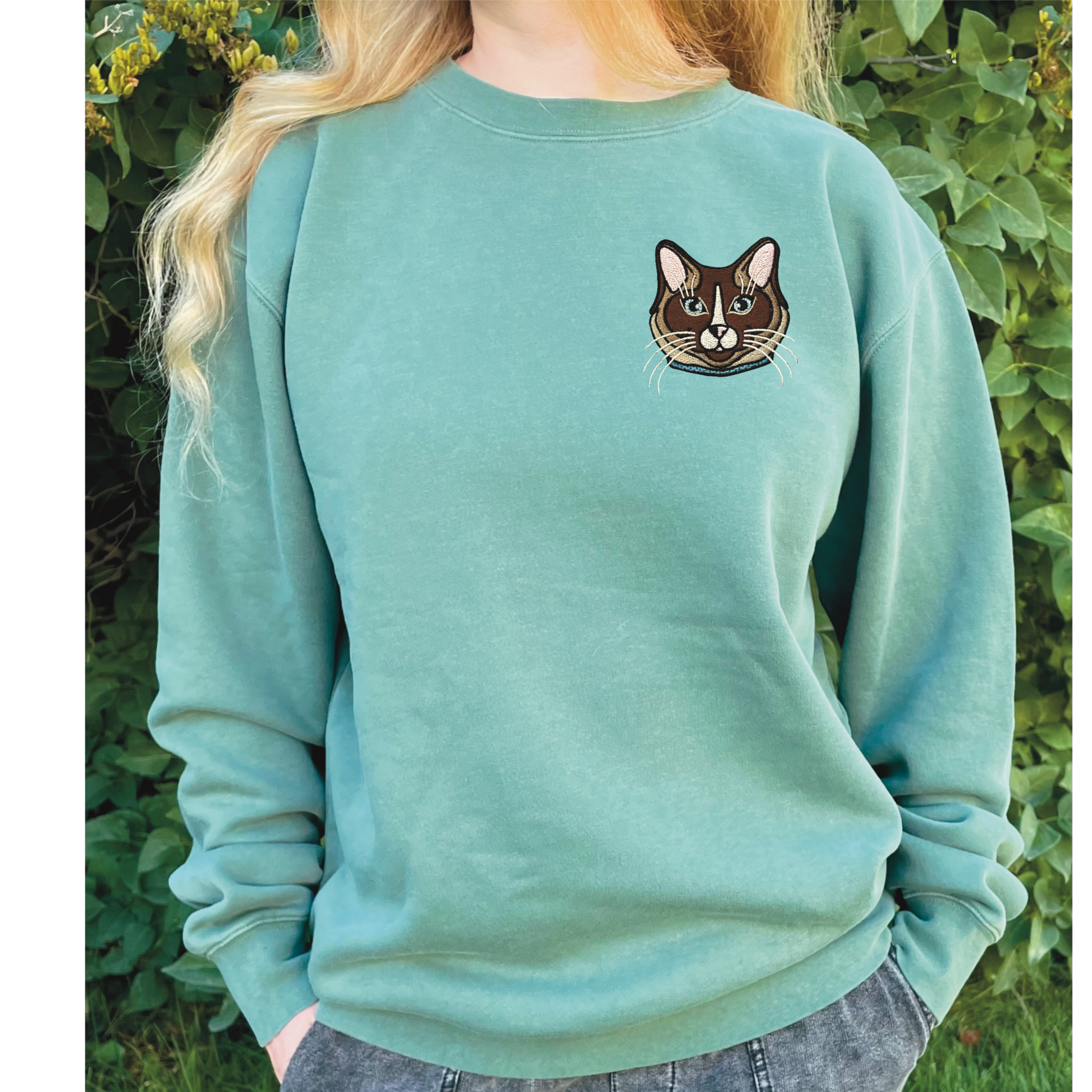 Ragdoll, Snowshoe, Siamese Cat embroidered on a crewneck sweatshirt color pigment forest green design is 4x4 inches on the left chest. Available in sizes S-3XL.