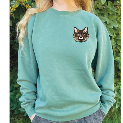 Ragdoll, Snowshoe, Siamese Cat embroidered on a crewneck sweatshirt color pigment forest green design is 4x4 inches on the left chest. Available in sizes S-3XL.