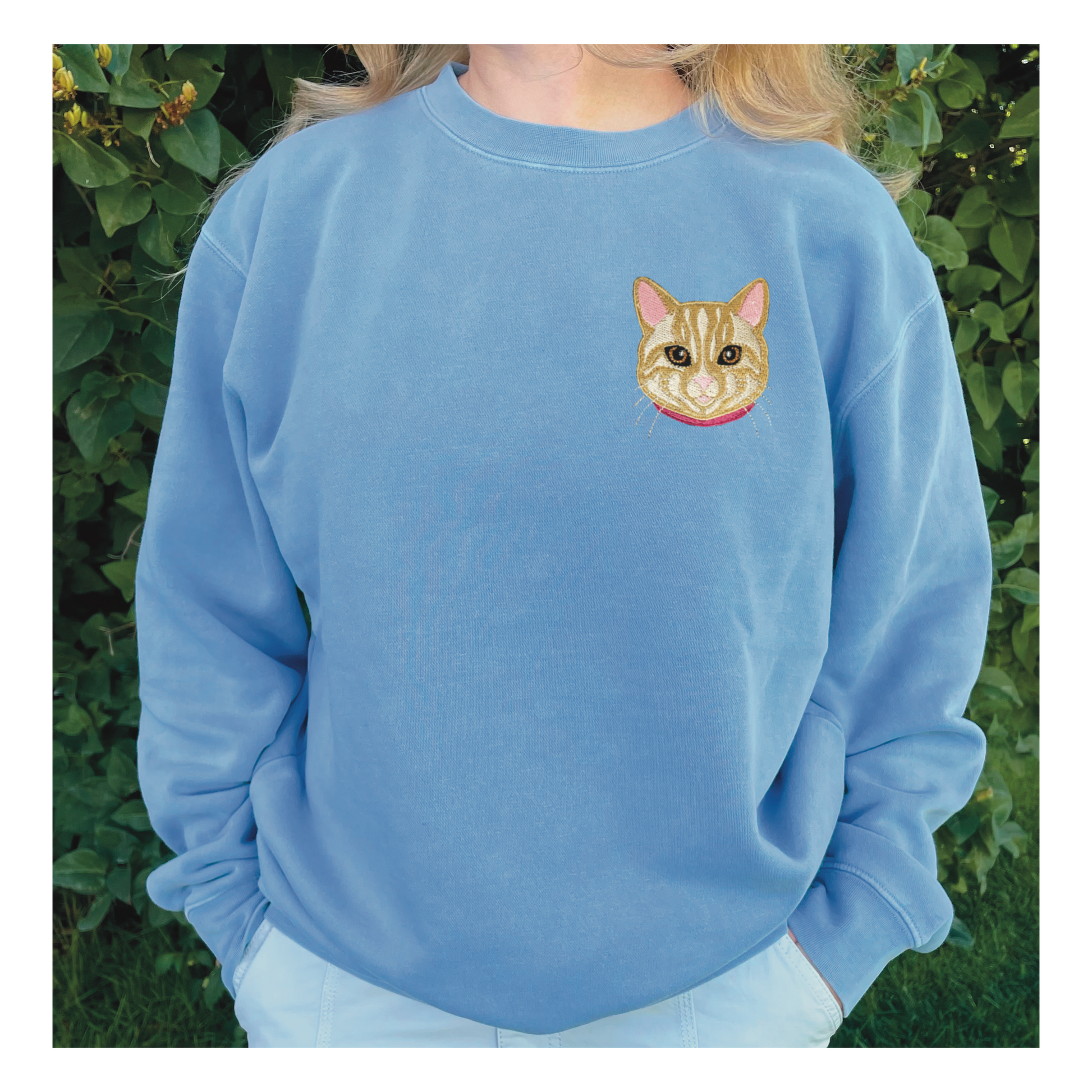 Cream/Tan Tabby Cat Embroidered Crewneck Sweatshirt. Design is 4x4 inches left chest. Available in sizes S-3XL on Baby Blue Sweatshirt. 